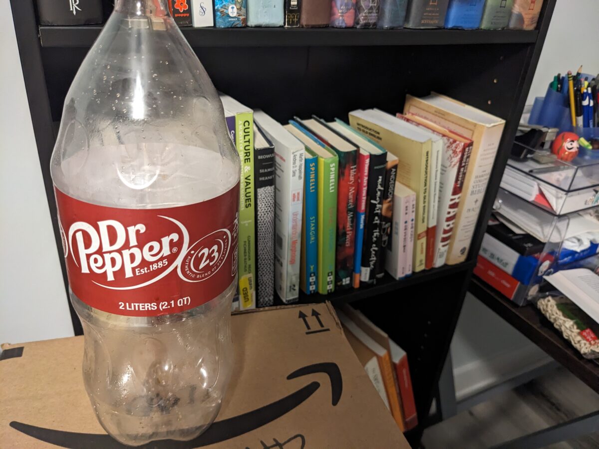 A bottle of Dr. Pepper in my somewhat cluttered apartment